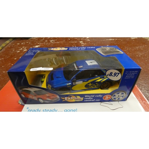 2 track race sets together with a remote control Subaru