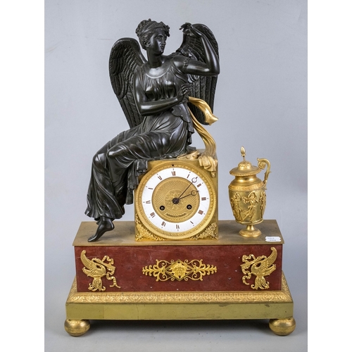 A French bronze and ormolu mantle clock.  Silk suspension movement, with machined gilt dial and enamel chapter ring, surmounted by a seated female figure with wings. The marble base with ormolu appliques - Approx H 53cm W: 40cm