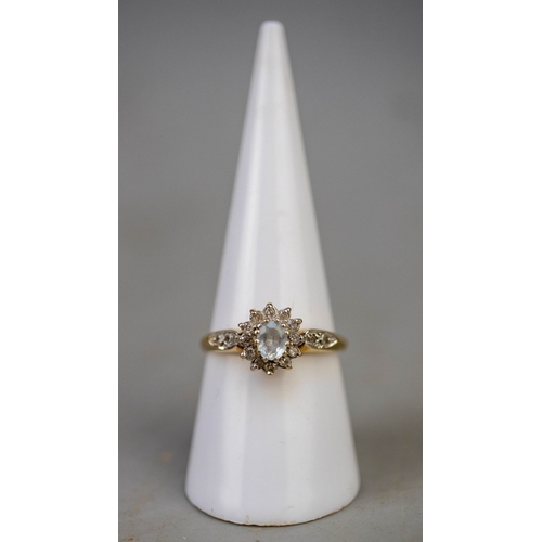 124 - 9ct gold aquamarine and diamond set ring