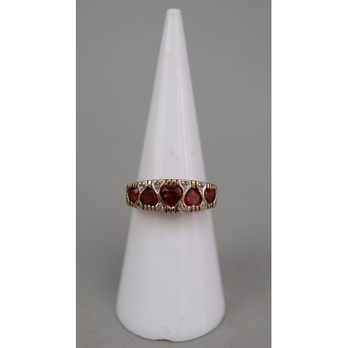 125 - 9ct gold 5 heart shaped garnet set ring, plus small white (diamond like) stones surrounding, and ben... 