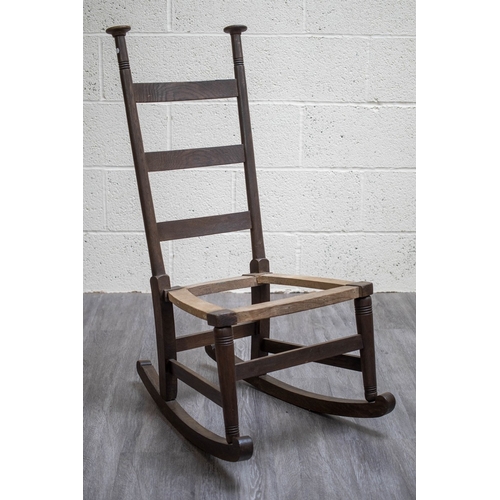 660 - An oak Liberty's style rocking chair