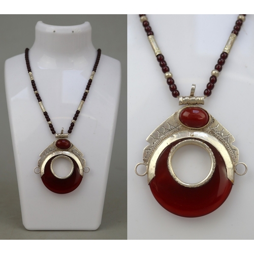 67 - Amber and silver pendant on beaded necklace