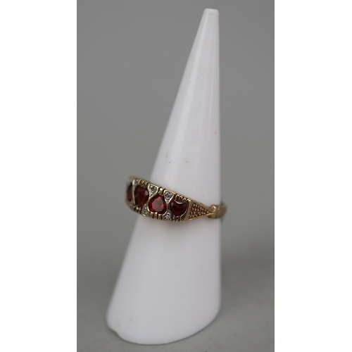 125 - 9ct gold 5 heart shaped garnet set ring, plus small white (diamond like) stones surrounding, and ben... 