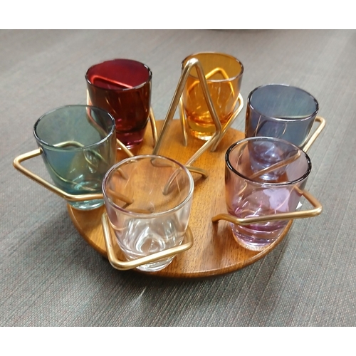 347 - Pair of 1960s orange glass candle holders together with mid century multicoloured shot glasses