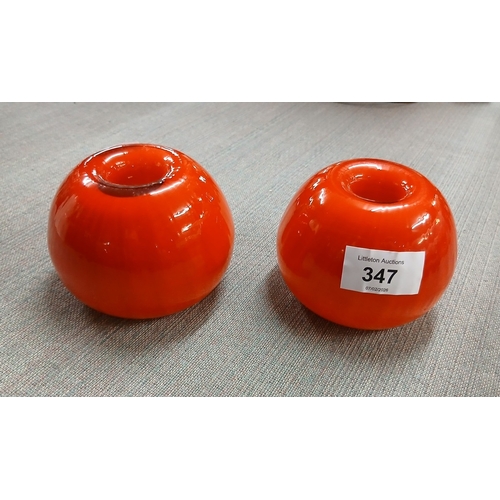 347 - Pair of 1960s orange glass candle holders together with mid century multicoloured shot glasses