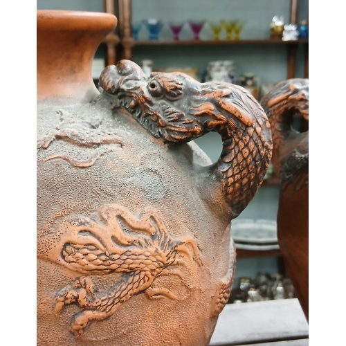 393 - A pair of dragon handled Oriental urns - Approx H: 26cm