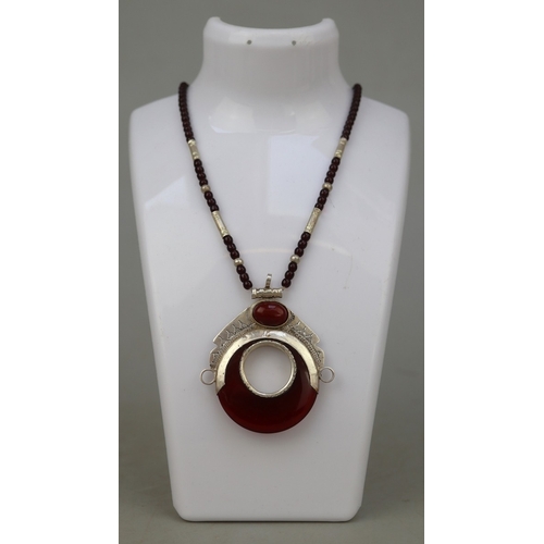 67 - Amber and silver pendant on beaded necklace