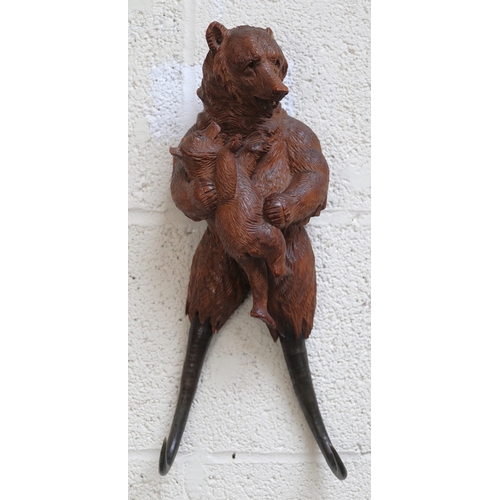 506 - Musical hand Carved wooden Swiss Black Forest Bear with chamois horn coat hooks - Damage to one ear