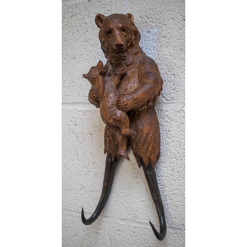 506 - Musical hand Carved wooden Swiss Black Forest Bear with chamois horn coat hooks - Damage to one ear