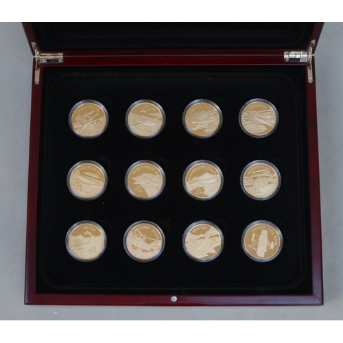 173 - A collection of 12 .999 silver 24ct gold plated Solomon Islands, £25 airplane themed coins, presente... 