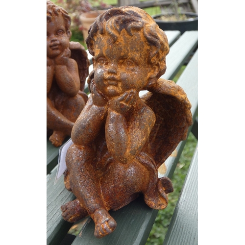 106 - Set a three cast iron cherubs