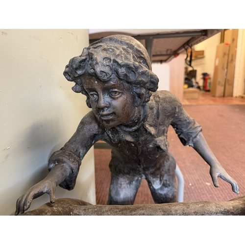 67 - Bronze - A large cast garden sculpture of children playing on a climbing frame - Approx L: 120cm H: ... 