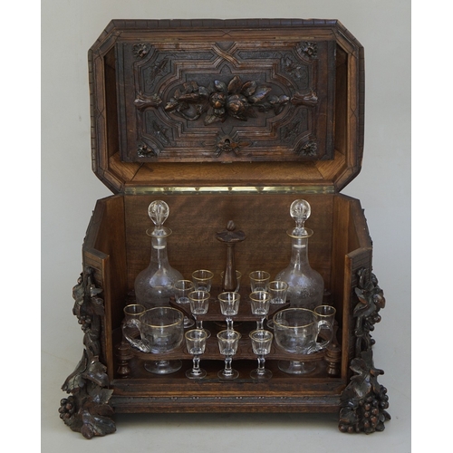 217 - Fine carved Black Forest decanter box complete with original contents - circa late 1800s