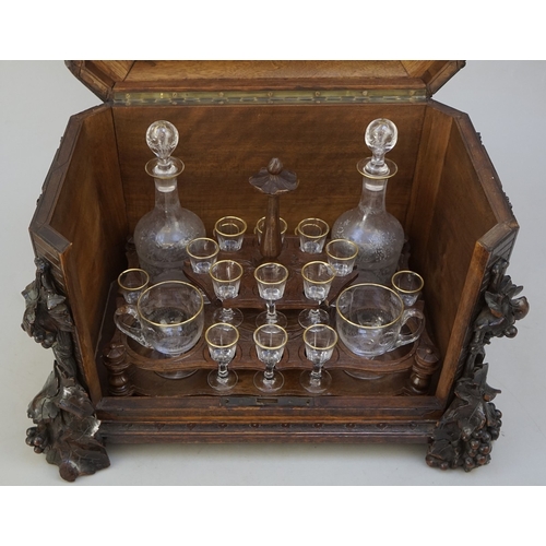 217 - Fine carved Black Forest decanter box complete with original contents - circa late 1800s