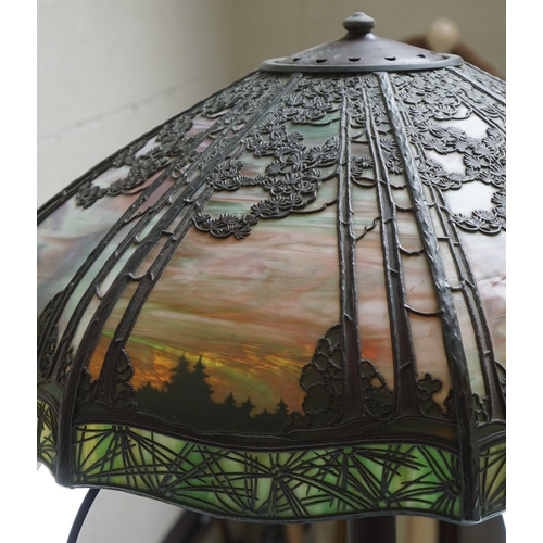 551 - Floor lamp by Handel with pine woods sunset shade, patinated bronze and painted slag glass shade wit... 