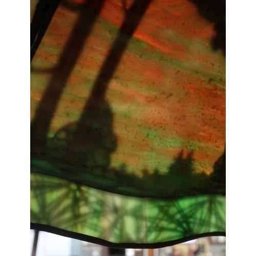 551 - Floor lamp by Handel with pine woods sunset shade, patinated bronze and painted slag glass shade wit... 