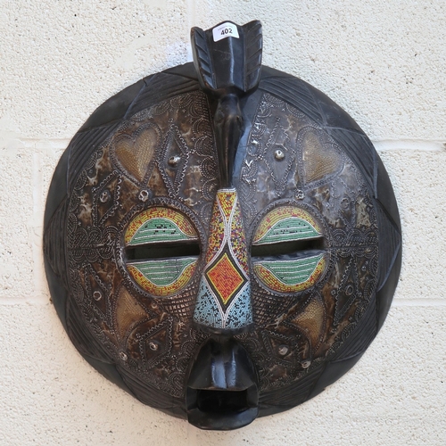 402 - Hand carved Ghanaian wooden tribal mask with metal and bead inlay - Approx Di: 46cm