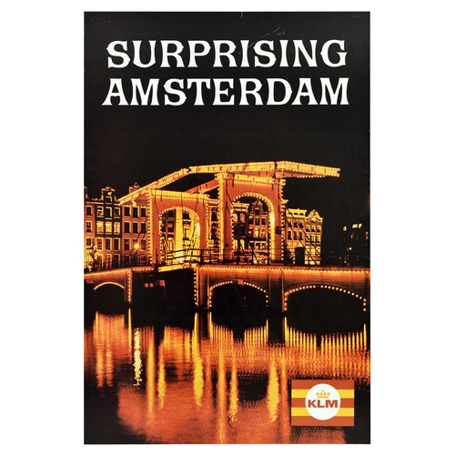 Travel Poster Surprising Amsterdam KLM Netherlands. Original vintage travel advertising poster issued by KLM Royal Dutch Airlines � Surprising Amsterdam � featuring a great photograph of Magere Brug or Skinny Bridge over Amstel river, with warm yellow lights reflecting in the water and building in the background, KLM logo in the bottom right corner. KLM (Koninklijke Luchtvaart Maatschappij / Royal Dutch Airlines; since 1919) is the flag carrier of the Netherlands.  Good condition, creasing, pinholes, tears, scuff marks. Country of issue: Netherlands, designer: Unknown, size (cm): 92x61, year of printing: 1960s.
