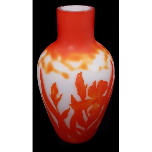 20 - A cameo glass vase, in Galle style, the  frosted white body cased in bright orange and cut through w... 