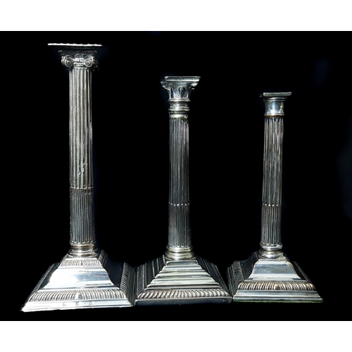 48 - Three silver plated Corinthium column candlesticks, each on stepped square base, 31.5cm high and sma... 