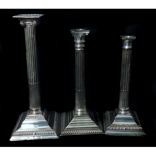 48 - Three silver plated Corinthium column candlesticks, each on stepped square base, 31.5cm high and sma... 