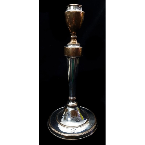 52 - A pair of silver plate on brass candlesticks, the circular bases cast with wrythen fluting within be... 