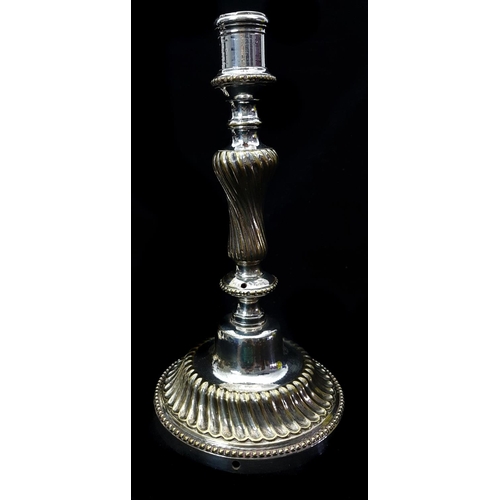 52 - A pair of silver plate on brass candlesticks, the circular bases cast with wrythen fluting within be... 