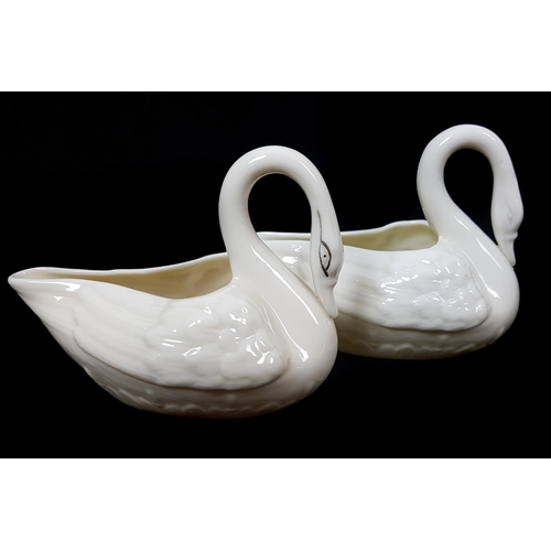 8 - Belleek Porcelain - Two swan shape cream jugs, one with yellow tint, 2nd green mark 1955 - 1965 and ... 