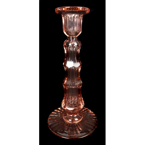 86 - A Moser Royalit cut glass candlestick, of rose pink colour, the tapered step cut column on starburst... 