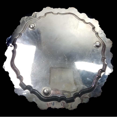 41 - A silver plated salver, of shaped circular form, the edge of well cast foliate 's' scrolls and scall... 