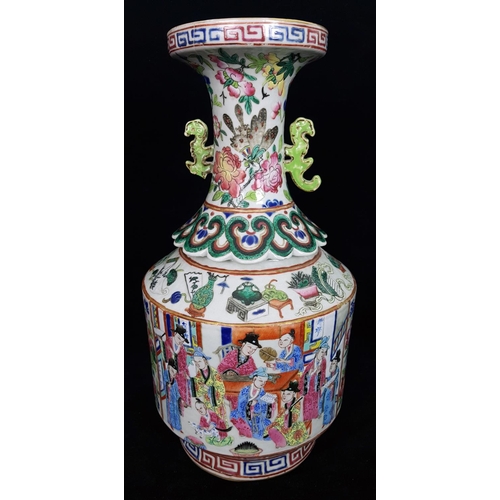 119 - An unusual Chinese famille rose bottle form vase, the trumpet neck with pierced scroll handles and a... 