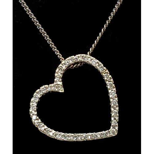 190 - A white gold and diamond set heart form pendant, set with 30 round stones, off set suspension apertu... 