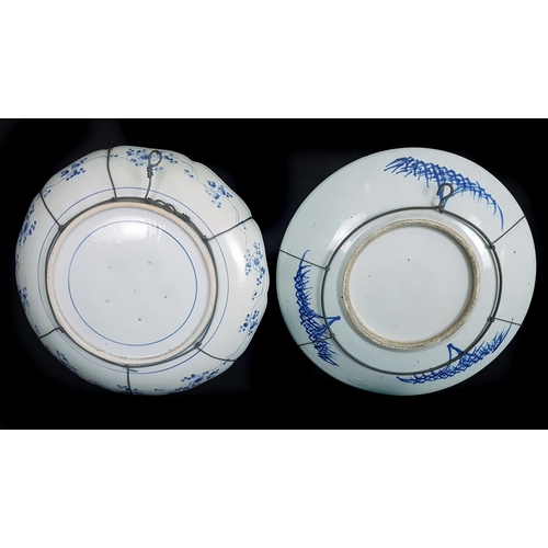 125 - Two Oriental porcelain blue and white chargers, one probably Japanese Arita porcelain, decorated wit... 