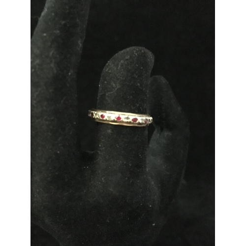 6 - A diamond and ruby full eternity ring, set in yellow and white metal, unmarked; a diamond chip illus... 