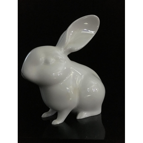 44 - Jeanne Grut for Royal Copenhagen - A porcelain figure of a rabbit, with blue eyes, shape number 4705... 