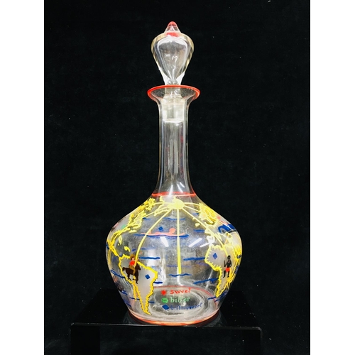 66 - A novelty decanter and stopper, the bottle form body enamelled with countries of the world with figu... 