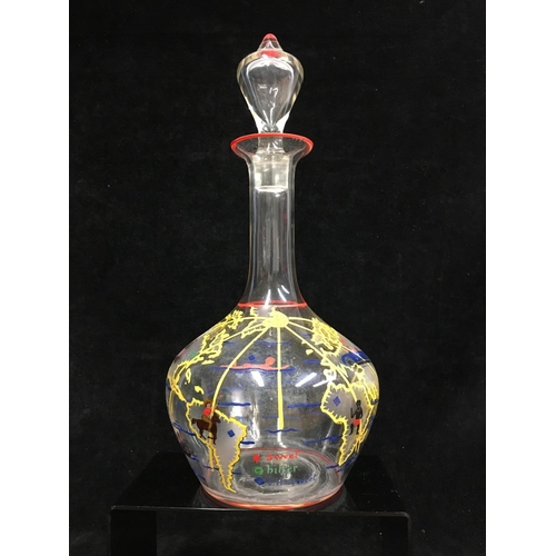 66 - A novelty decanter and stopper, the bottle form body enamelled with countries of the world with figu... 