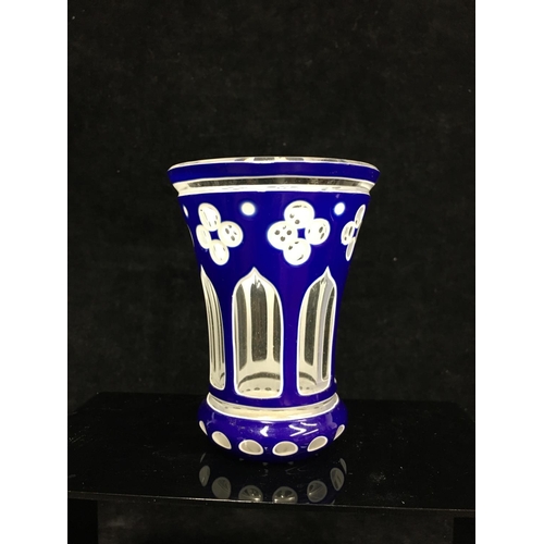 79 - A Bohemian cased glass spa beaker, blue and white overlay cut through to colourless with quatrefoil ... 