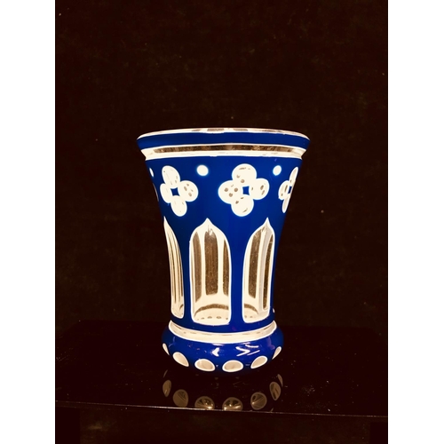 79 - A Bohemian cased glass spa beaker, blue and white overlay cut through to colourless with quatrefoil ... 