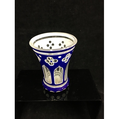 79 - A Bohemian cased glass spa beaker, blue and white overlay cut through to colourless with quatrefoil ... 