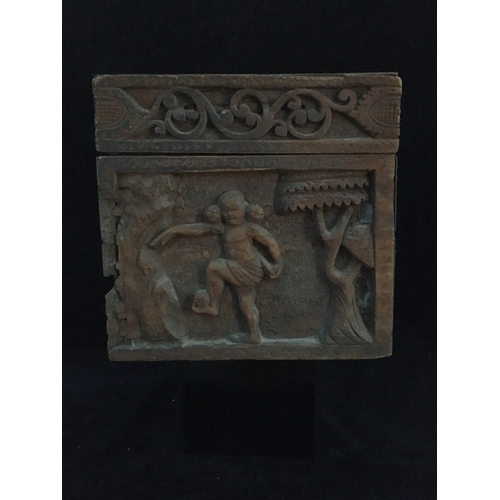 86 - An Indonesian carved wood box, decorated with a panel of figures and a tree within a scrolled border... 