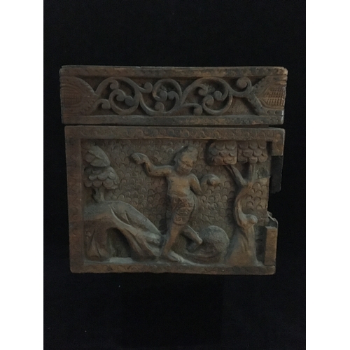 86 - An Indonesian carved wood box, decorated with a panel of figures and a tree within a scrolled border... 