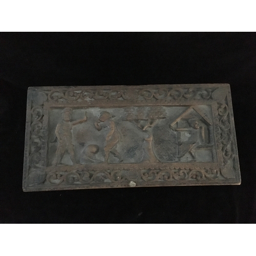 86 - An Indonesian carved wood box, decorated with a panel of figures and a tree within a scrolled border... 