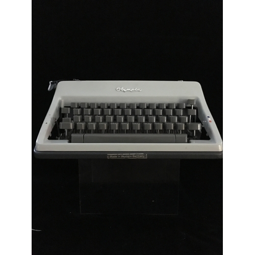 87 - An Olympia SM 9 portable typewriter, in hard case, script type, segment shift and full tabulation, c... 