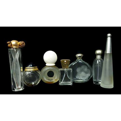 97 - A Group of Seven Commercial perfume bottles, comprising: L' Eau D' Issey - Parfums Issey Miyake, con... 