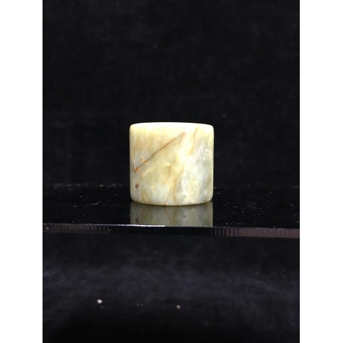 119 - A Chinese variegated green hardstone archers ring, 3.3cm diam max