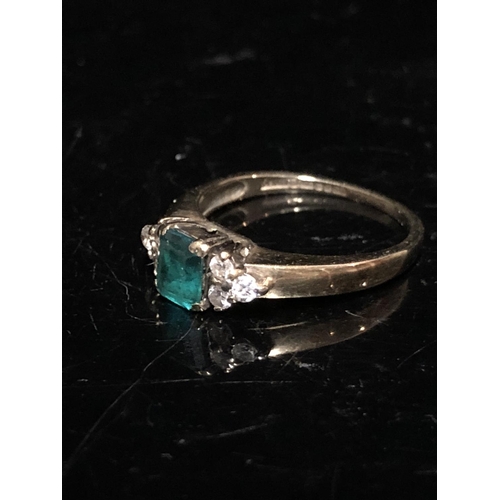 14 - An emerald and diamond set child's ring, the central synthetic emerald 4.64 x 3.85 approx split claw... 