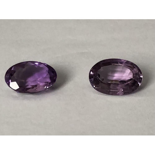 21 - Two natural amethyst stones, unmounted, oval, 12.03 ct and 12.69 ct (2)