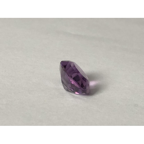 25 - A natural amethyst stone, unmounted, oval, 11.7 ct (2)