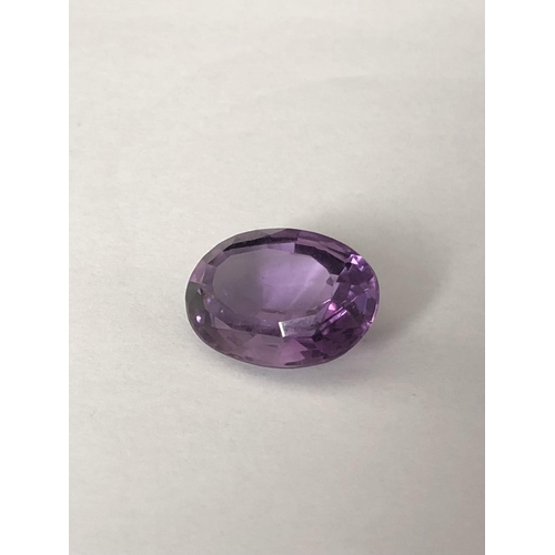 25 - A natural amethyst stone, unmounted, oval, 11.7 ct (2)